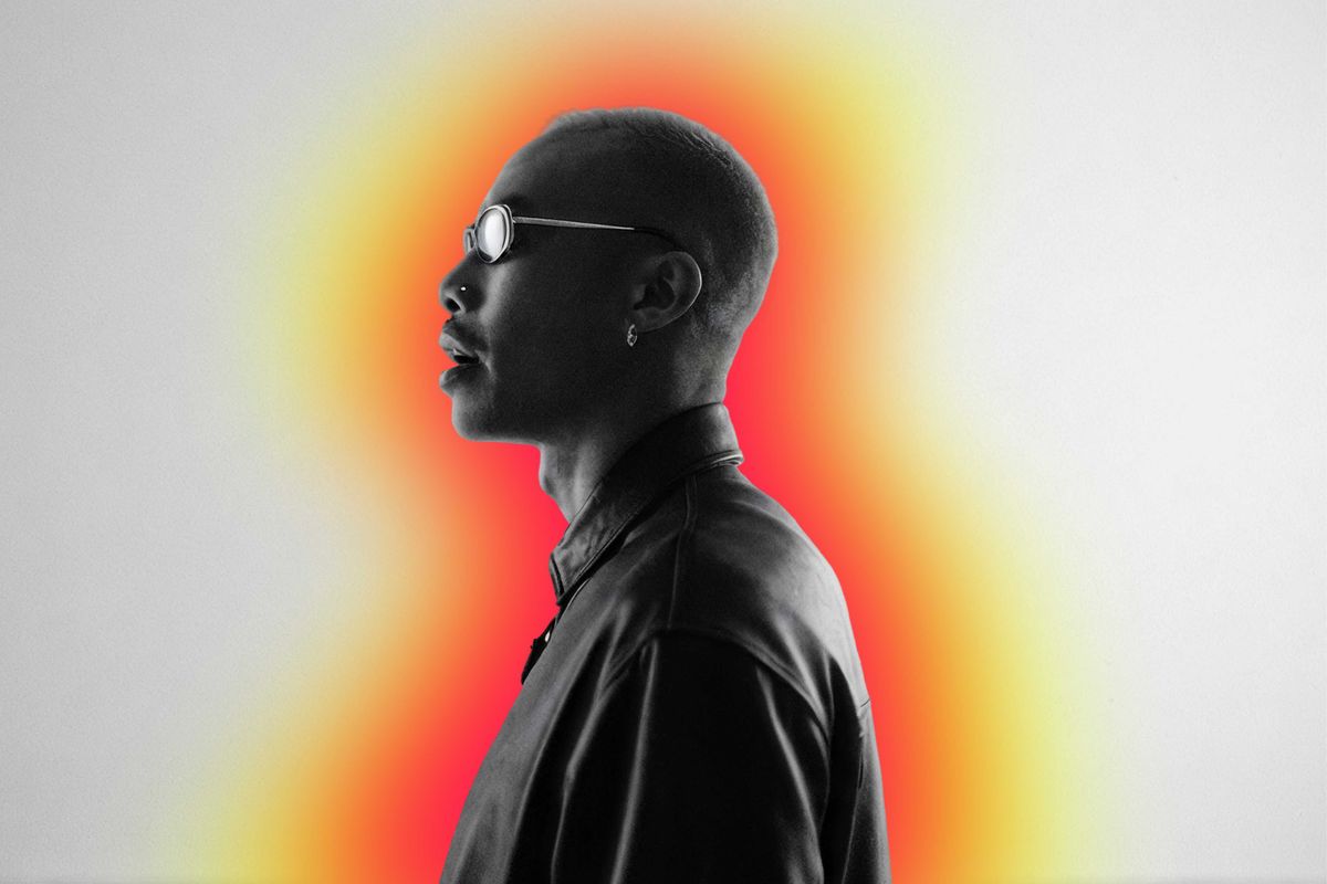A cool looking man in sunglasses and a leather coat with a visible aura