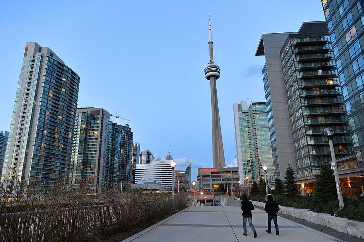 A line of condo buildings with Toronto's CN Tower in the background