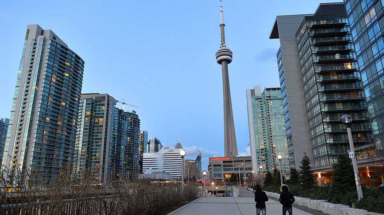 A line of condo buildings with Toronto's CN Tower in the background