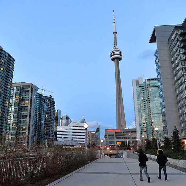 A line of condo buildings with Toronto's CN Tower in the background