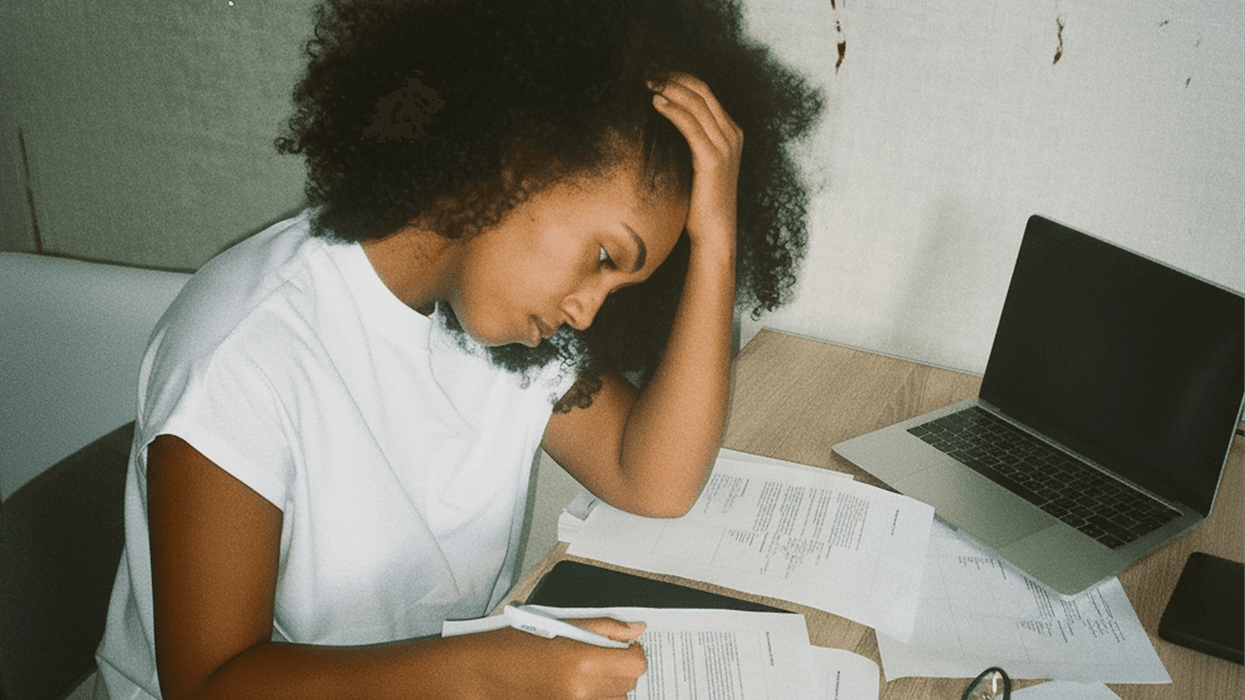 A stressed woman filling out piles of paperwork