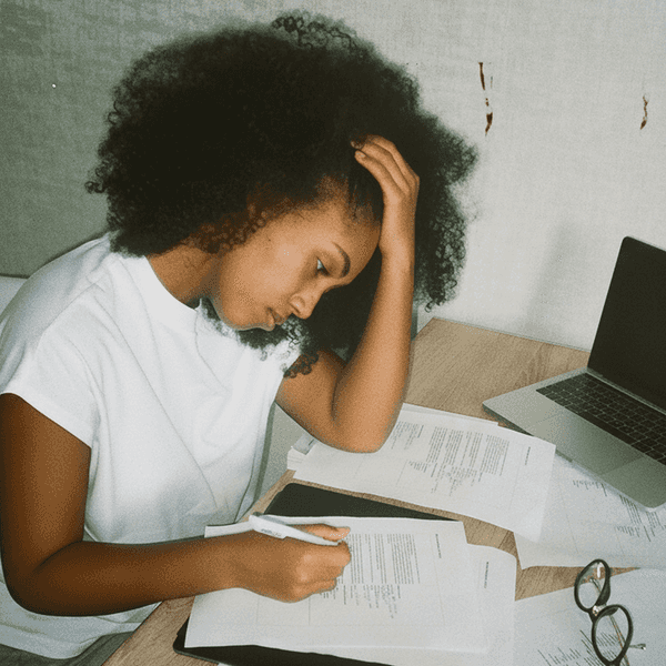 A stressed woman filling out piles of paperwork