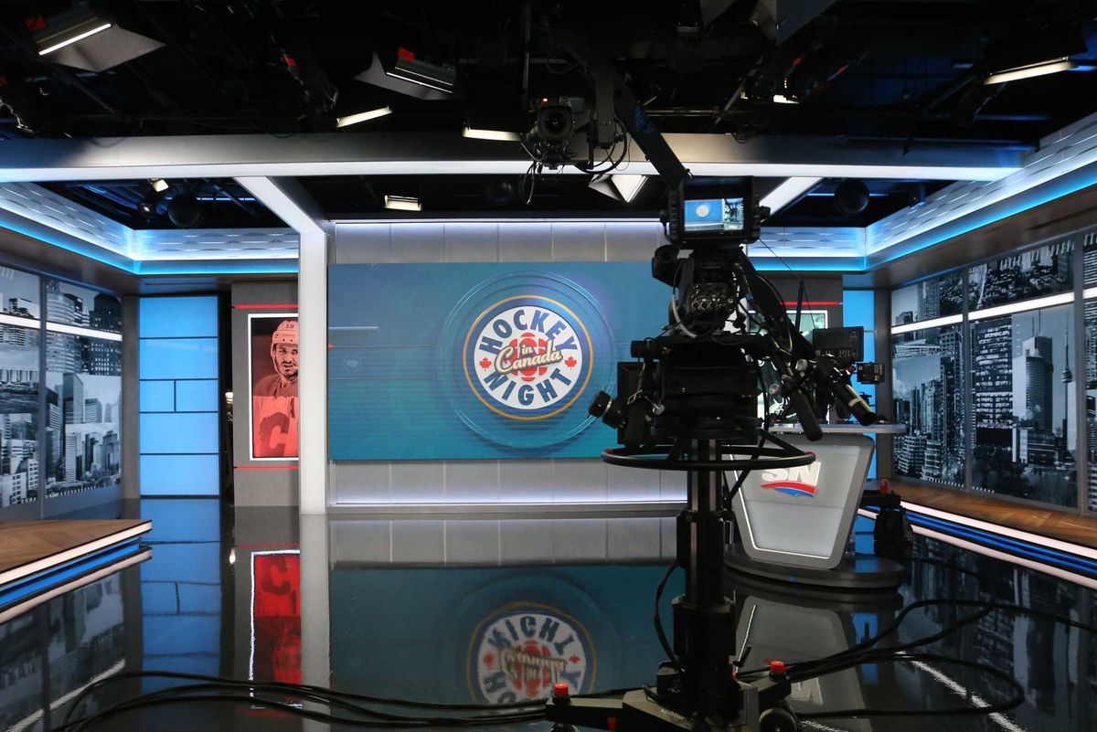 A TV camera points at the Hockey Night in Canada set.