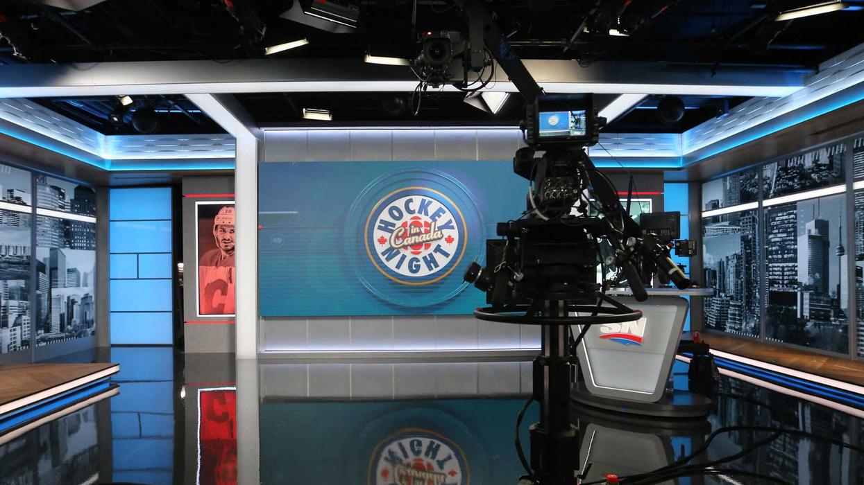 A TV camera points at the Hockey Night in Canada set.