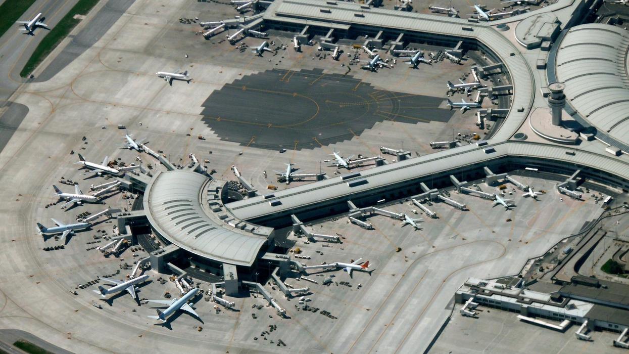 An aerial view of Toronto's Pearson Airport showing many planes docked at gates.
