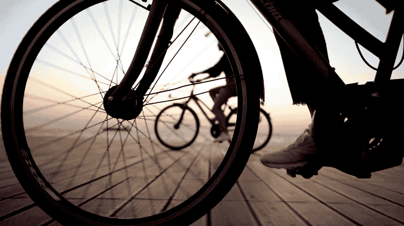 Animation close up of a bicycle wheel as the rider pedals