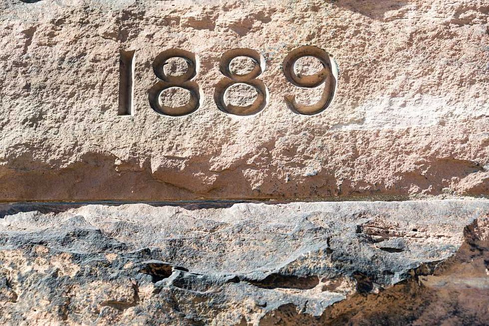 Bloor Street United's stone wall is pink underneath the decades of soot