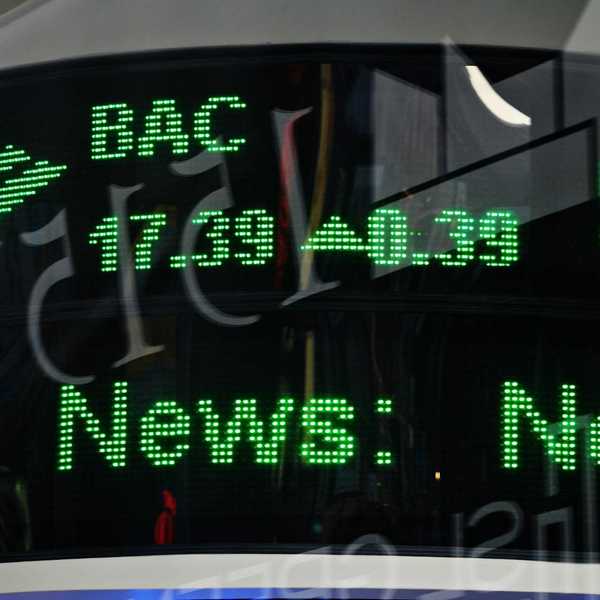 Green financial ticker displaying stock info.