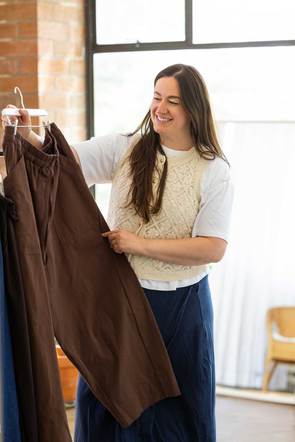 Jess Sternberg examines a pair of pants from Free Label