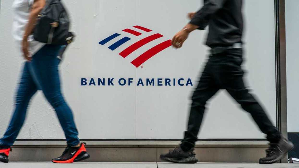 People walking in front of a Bank of America sign
