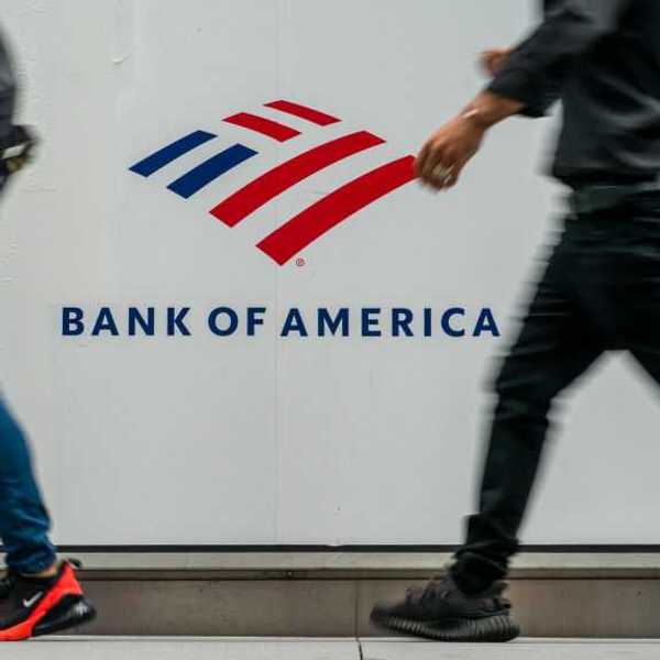 People walking in front of a Bank of America sign