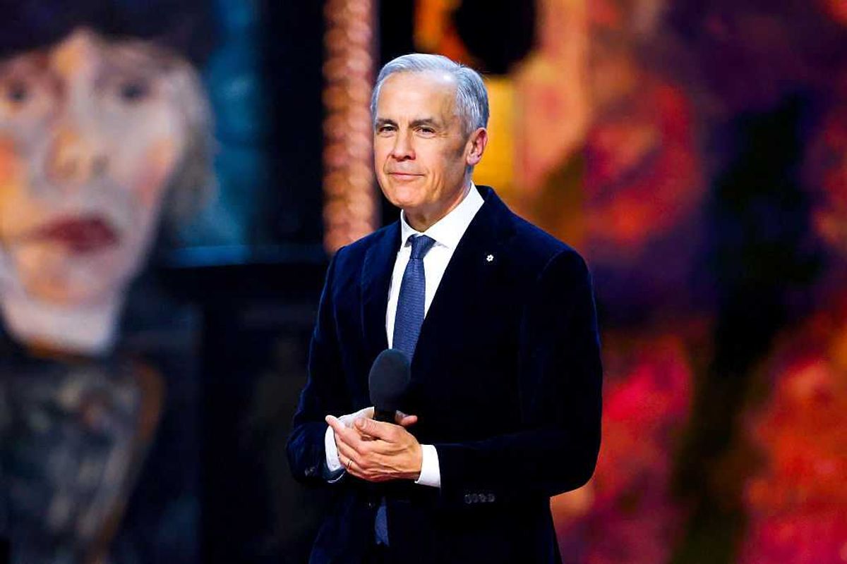 Prime Minister Mark Carney wearing Order of Canada pin, holding microphone