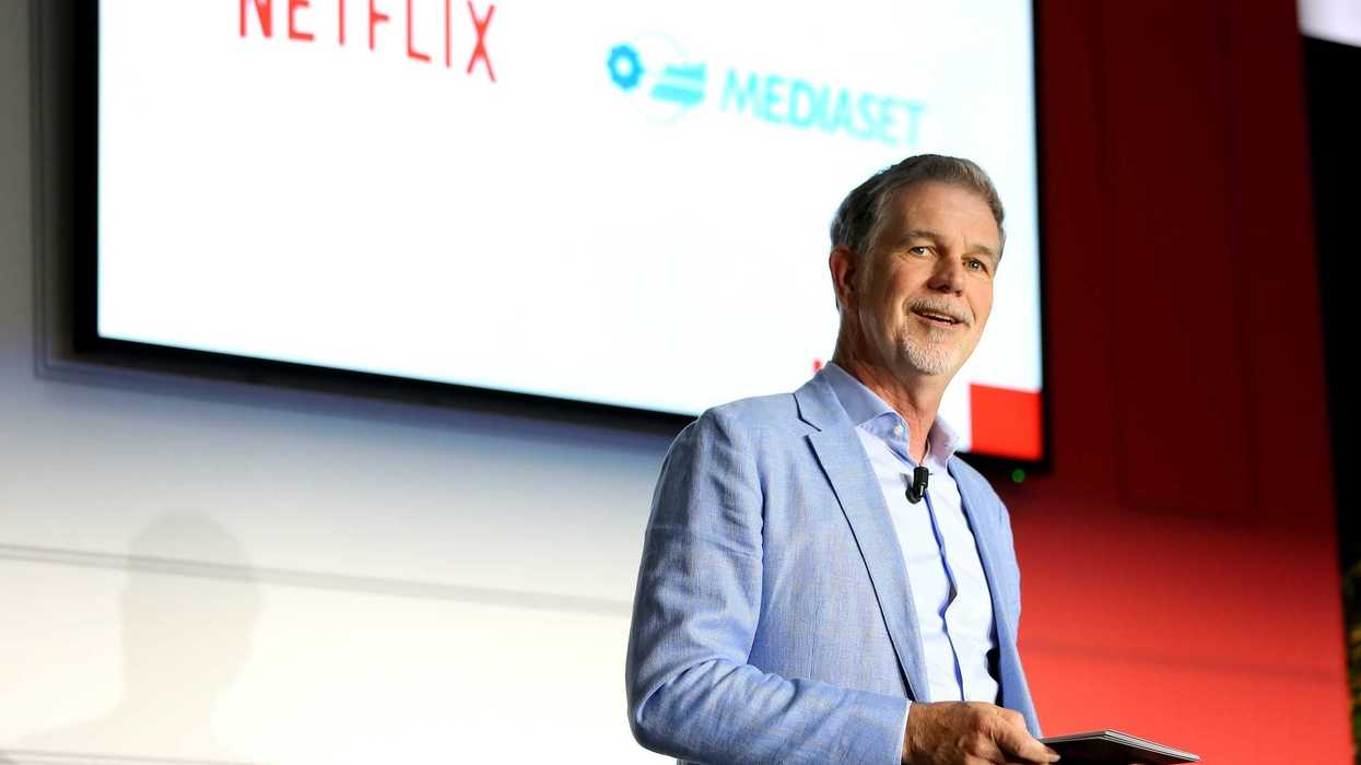 Reed Hastings standing on stage at a Netflix event
