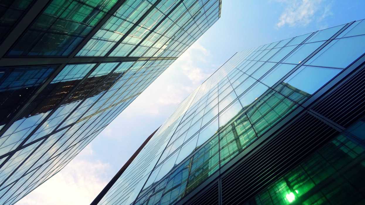 Reflective glass skyscrapers stretch into the air