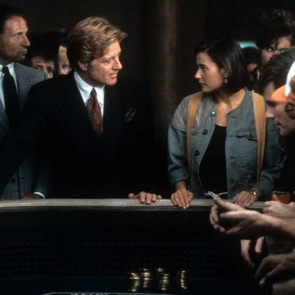 Robert Redford and Demi Moore intently face each other at a casino table