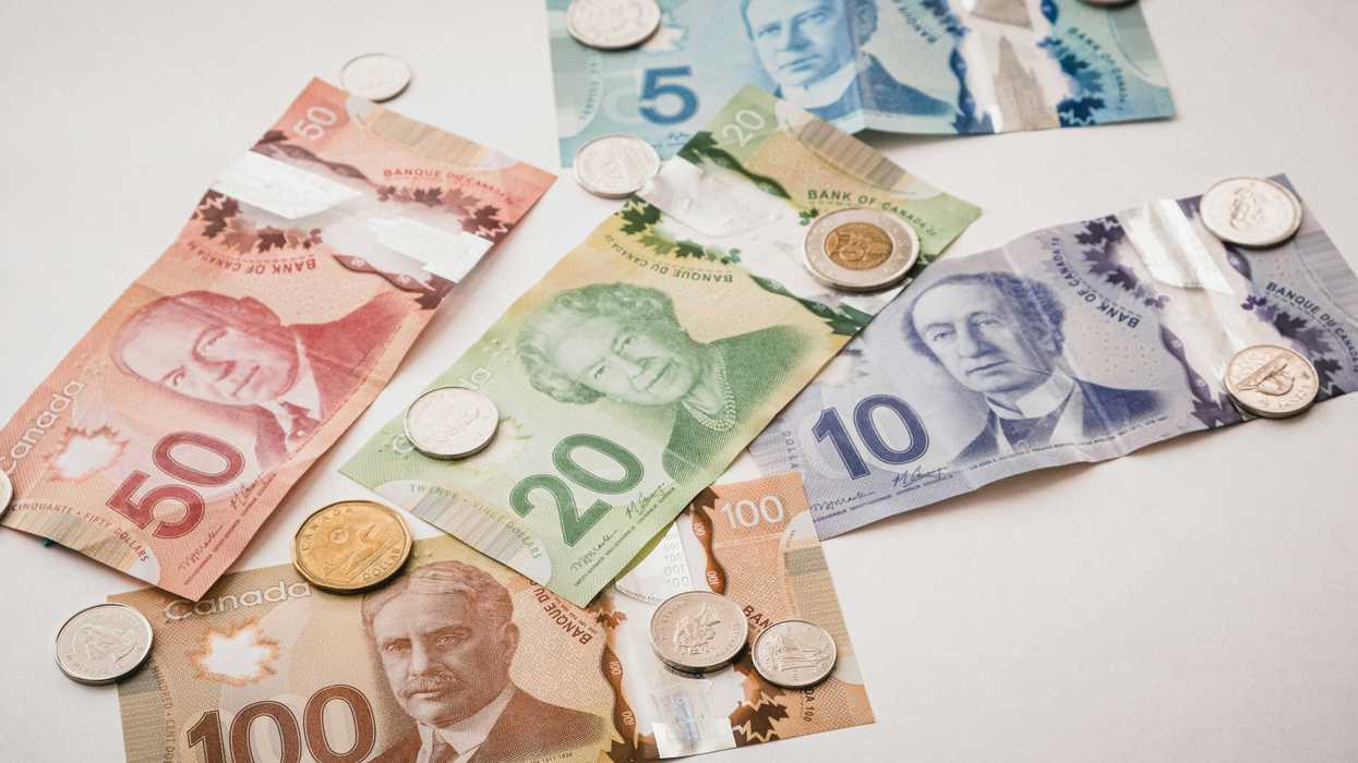 Several bills and coins of Canadian currency spread out