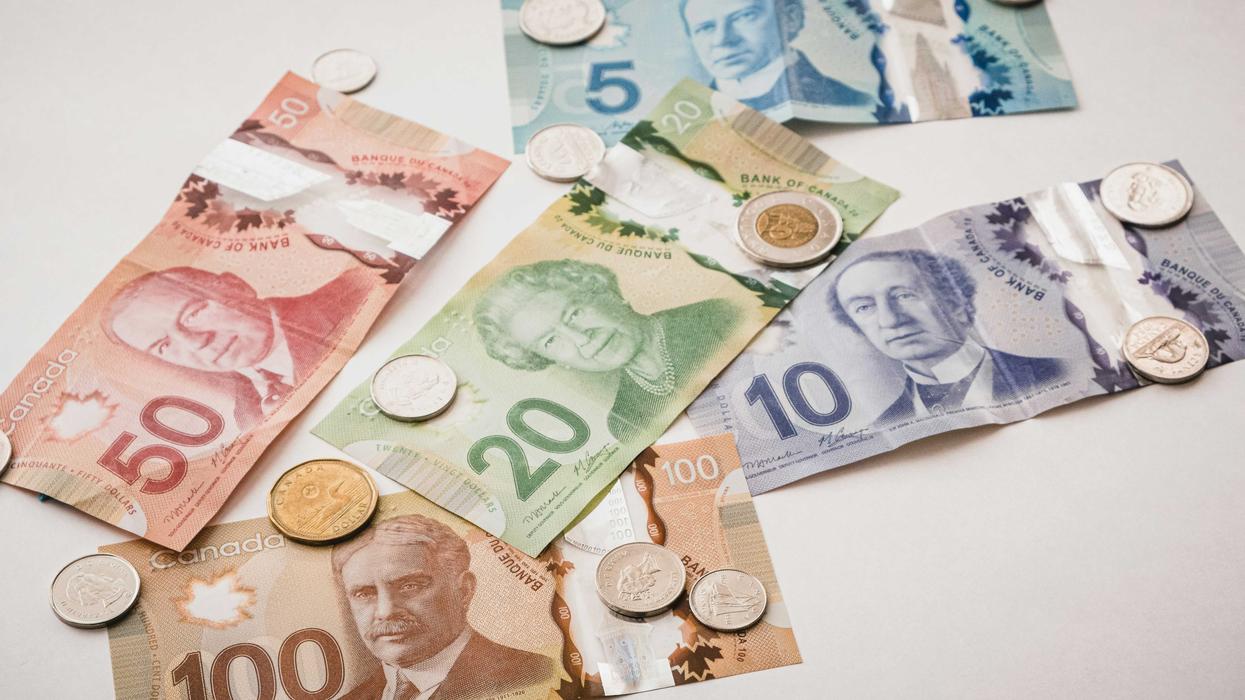 Several bills and coins of Canadian currency spread out
