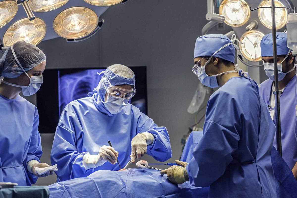 Several surgeons operating on a patient in a hospital