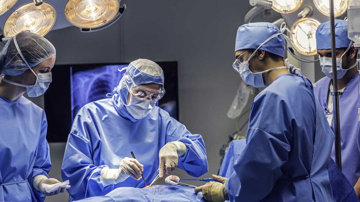 Several surgeons operating on a patient in a hospital