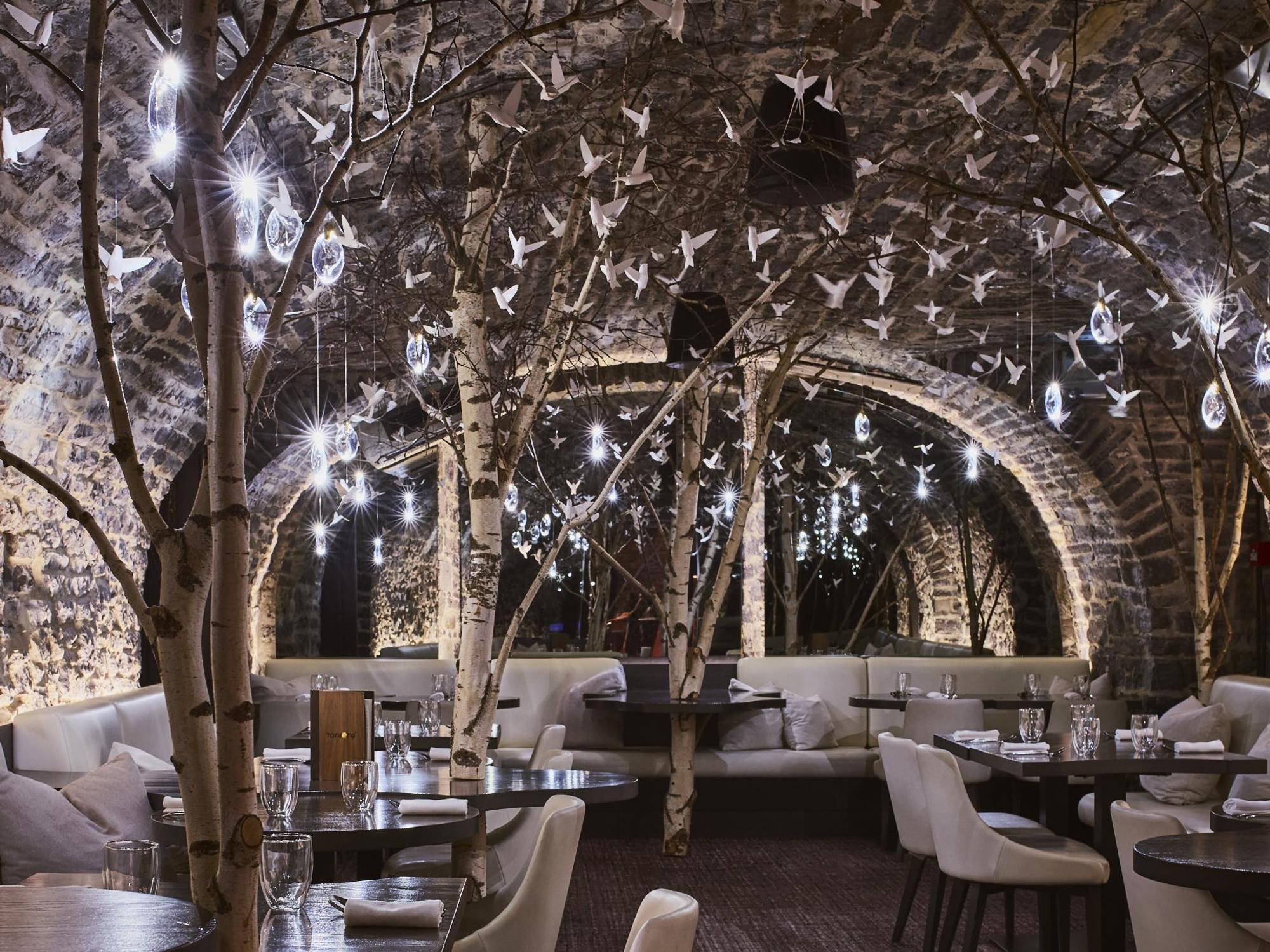 The Tani\u00e8re\u00b3 dining room features trees and dozens of paper birds