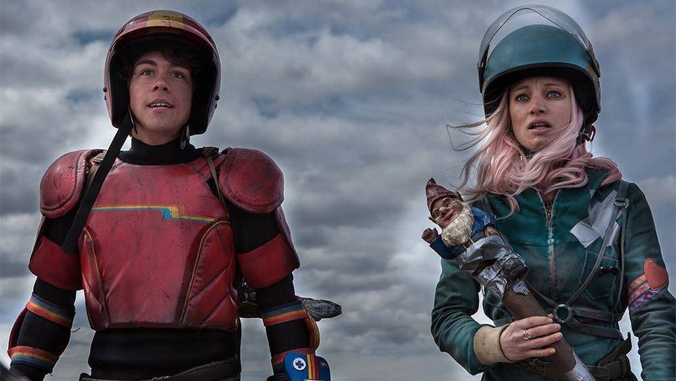 Two people dressed as superheroes in a dystopian wasteland